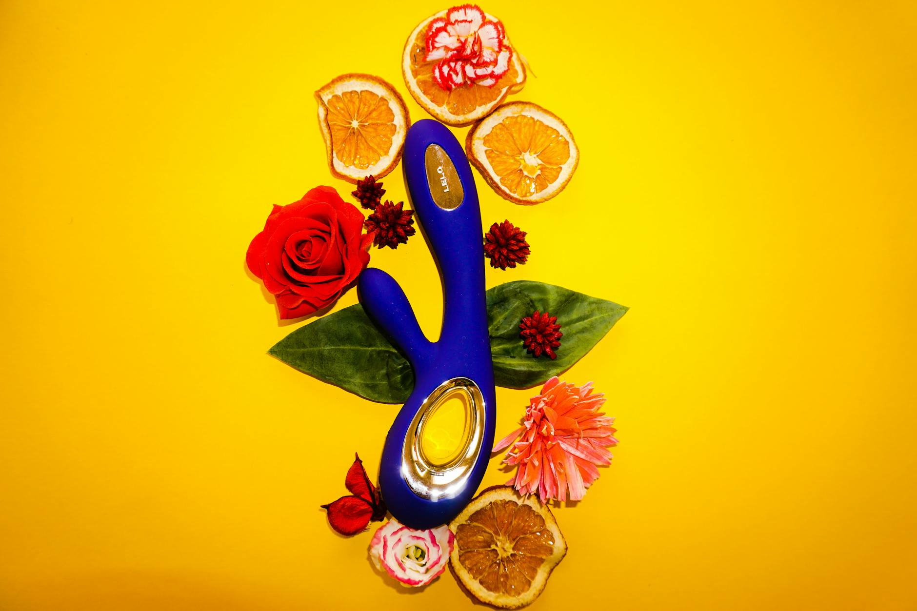 Woman holding a blue silicone vibrator, exploring pleasure without pressure or expectation.