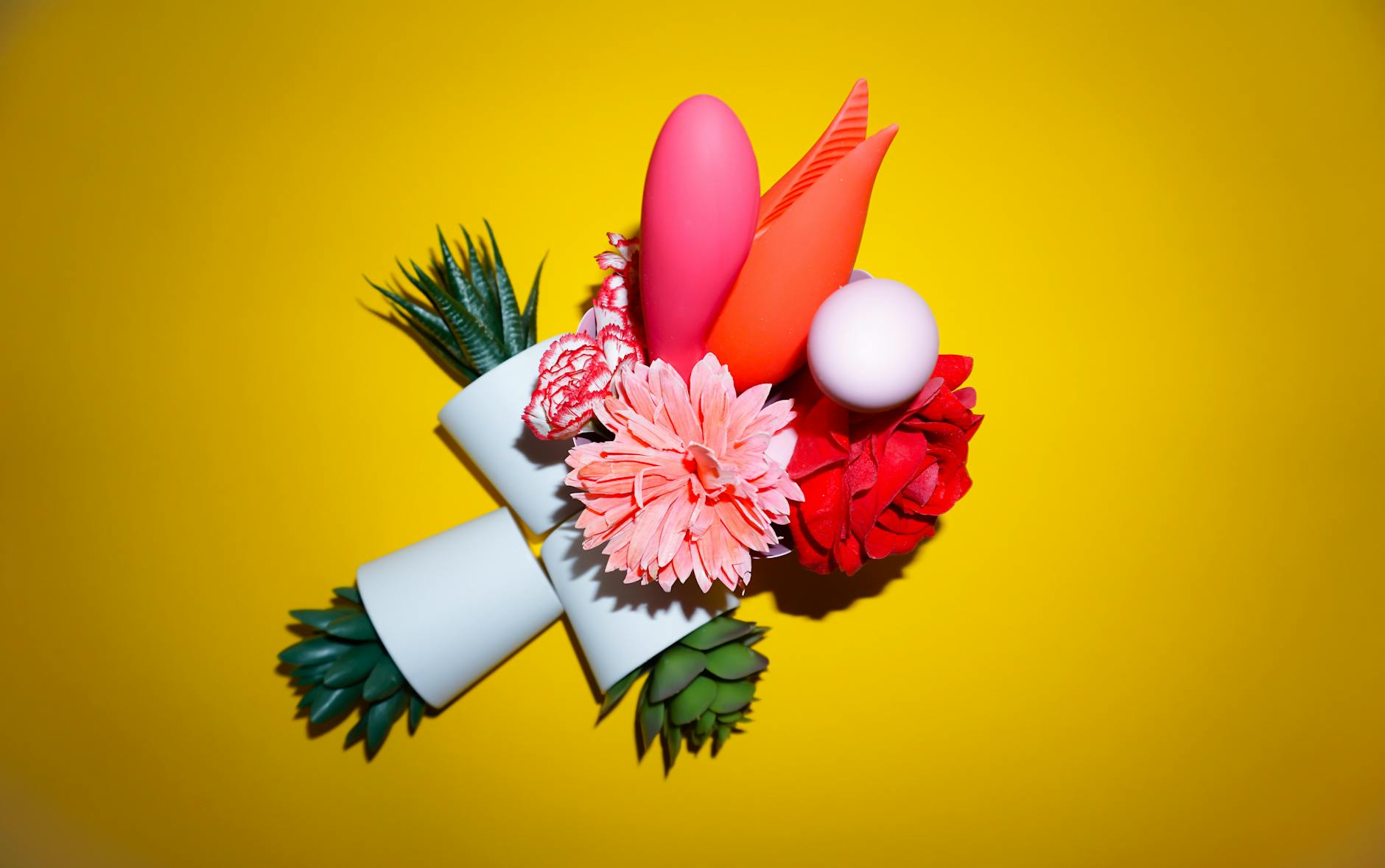 A hand holding a lemon on a soft pink background, representing fresh starts and intimate connection